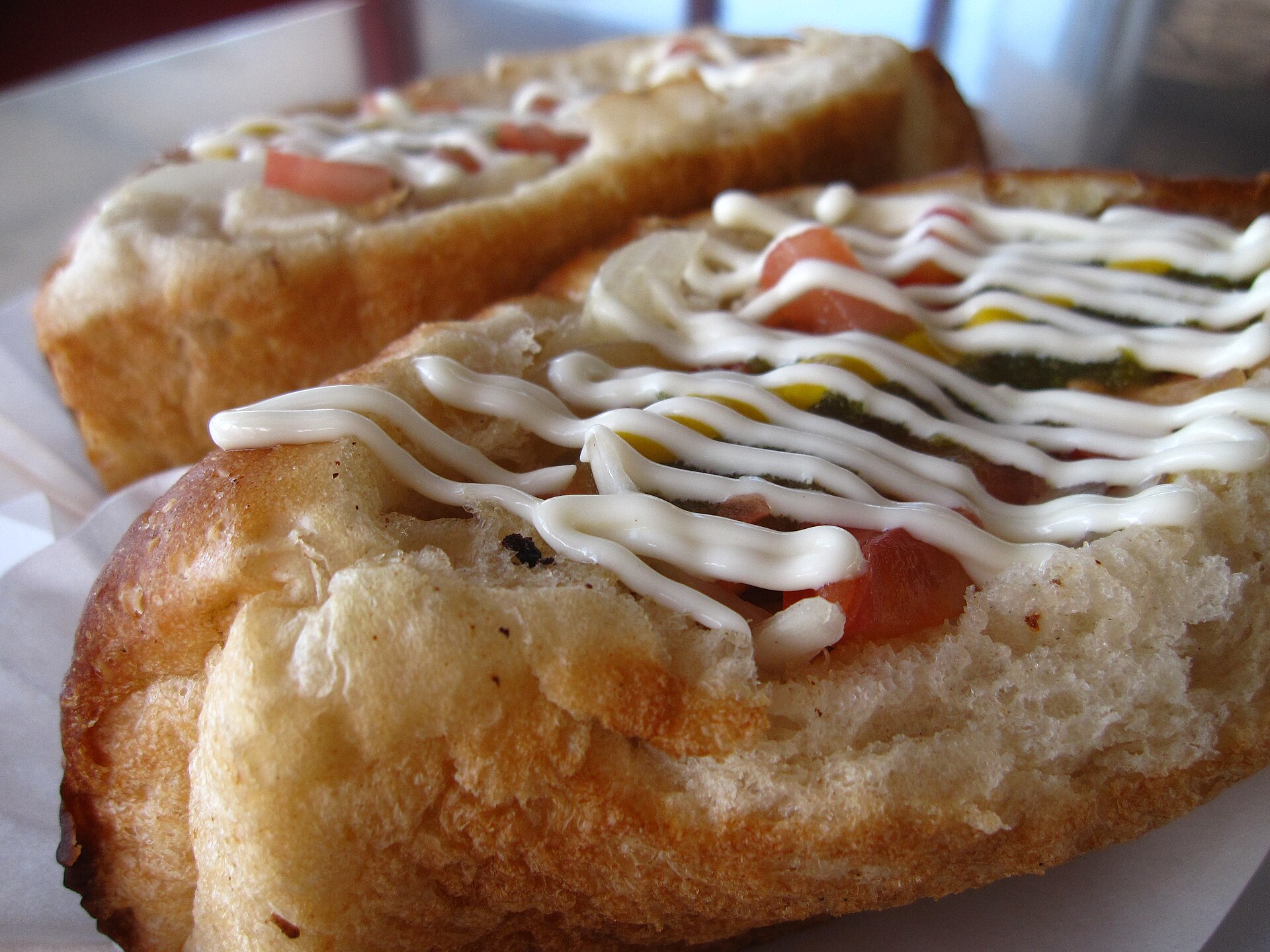 Sonoran hot dogs topped with tomatoes, mustard and mayonnaise at BK Carne Asada and Hot Dogs in Tucson