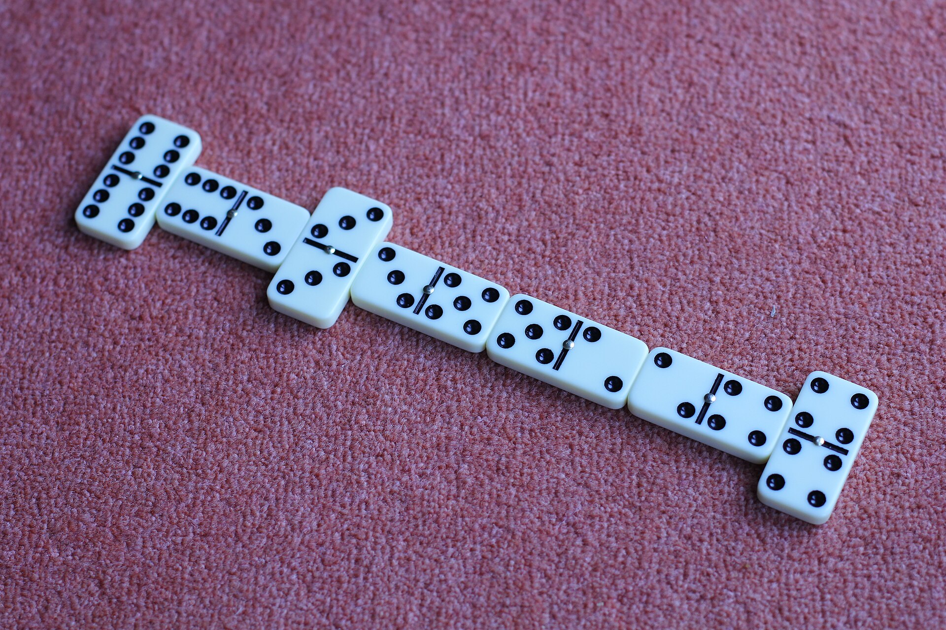 Domino tiles laid out on a table during a game