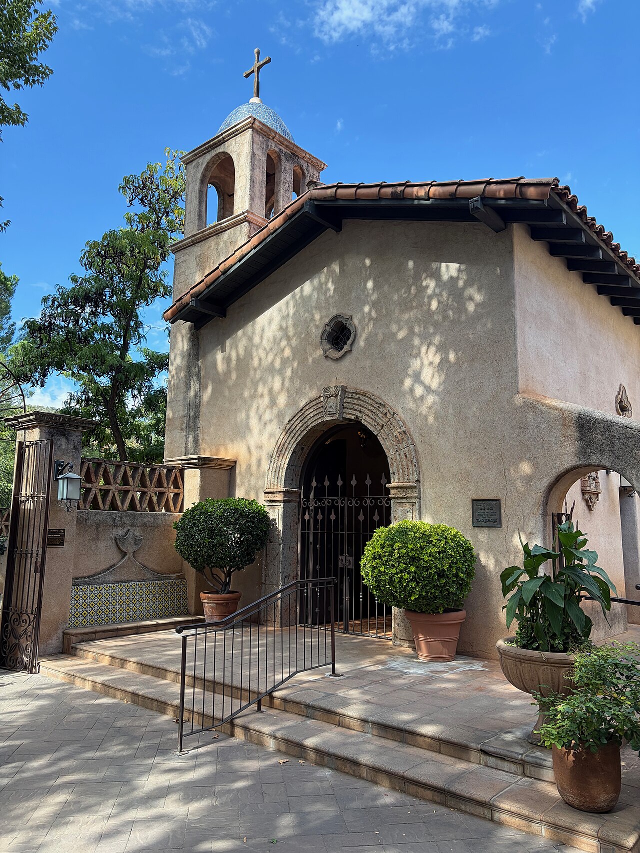 The small mission-style chapel at Tlaquepaque in Sedona, with white stucco walls and a bell tower topped by a cross